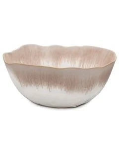 The Simon Pearce Burlington Dinnerware Bluff bowl features a wavy, irregular rim and smooth finish with a pink-and-white gradient—an organic piece that brings Burlington charm to your table.