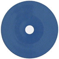 The Raynaud Tresor Dinnerware Blue features a round, flat blue disc with a small white central hole and a textured geometric pattern of raised squares for an elegant, woven look.
