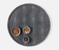 The Calvin Faux Shagreen Lazy Susan in grey by Blue Pheasant holds three small bowls with crackers, mixed nuts, and dark chocolate, all arranged on a white background.