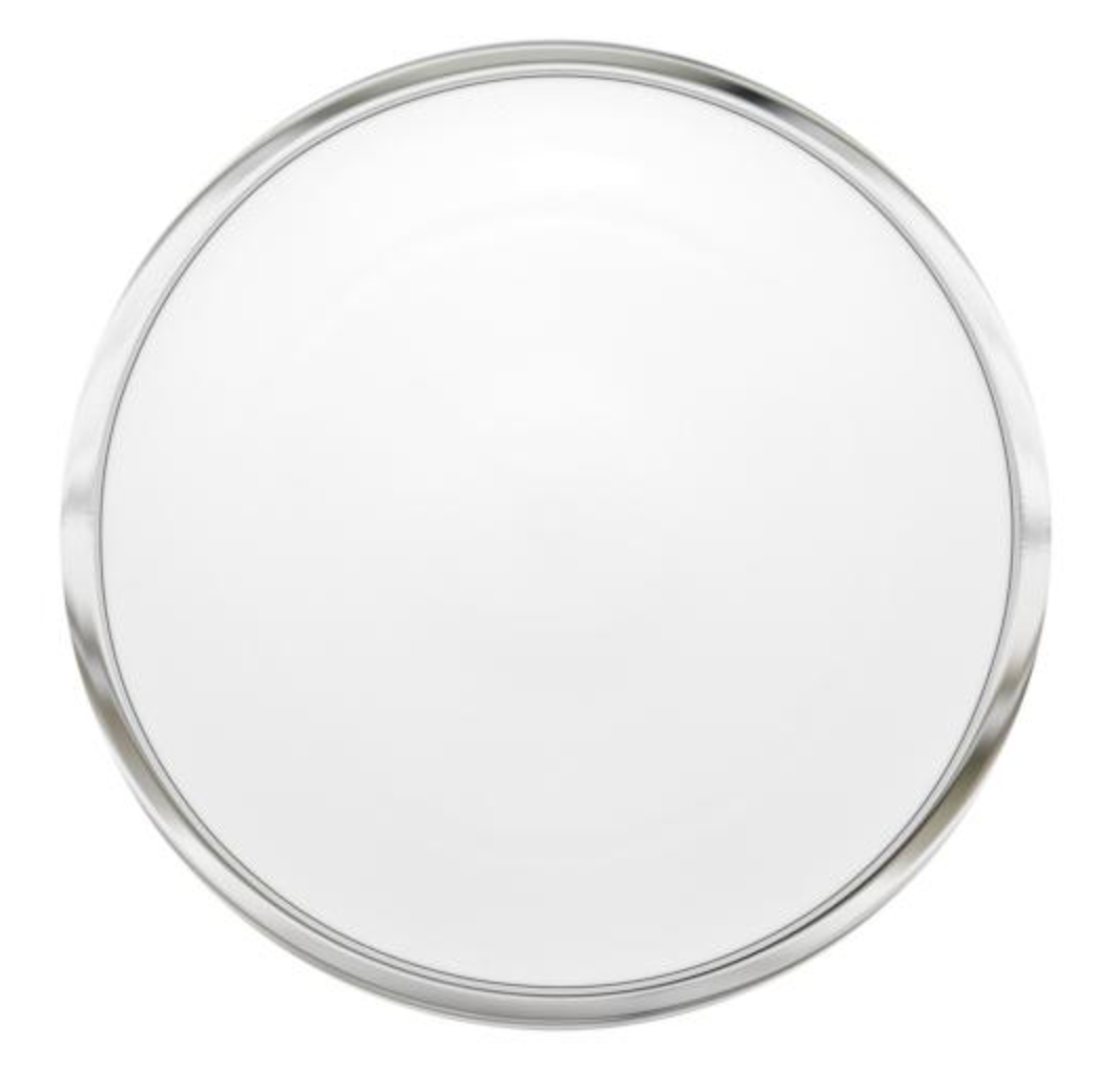 A round, empty metal serving tray with a shiny silver rim and smooth white surface, reminiscent of Vista Alegre’s Trasso Dinnerware, is viewed from above against a white background.