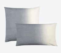 Two Johanna Howard Dip Dye Pillow Light Grey pillows—one square, one rectangular—feature a stylish ombré from gray to white and are displayed overlapping on a light gray background, perfect for anyone seeking a refined dip-dyed accent.