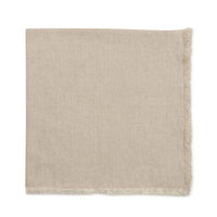 The Deborah Rhodes Herringbone Fringe Napkin Flax Set of 4 features light beige napkins with a subtle herringbone pattern and short fringe, reminiscent of a throw blanket, displayed on a white background.