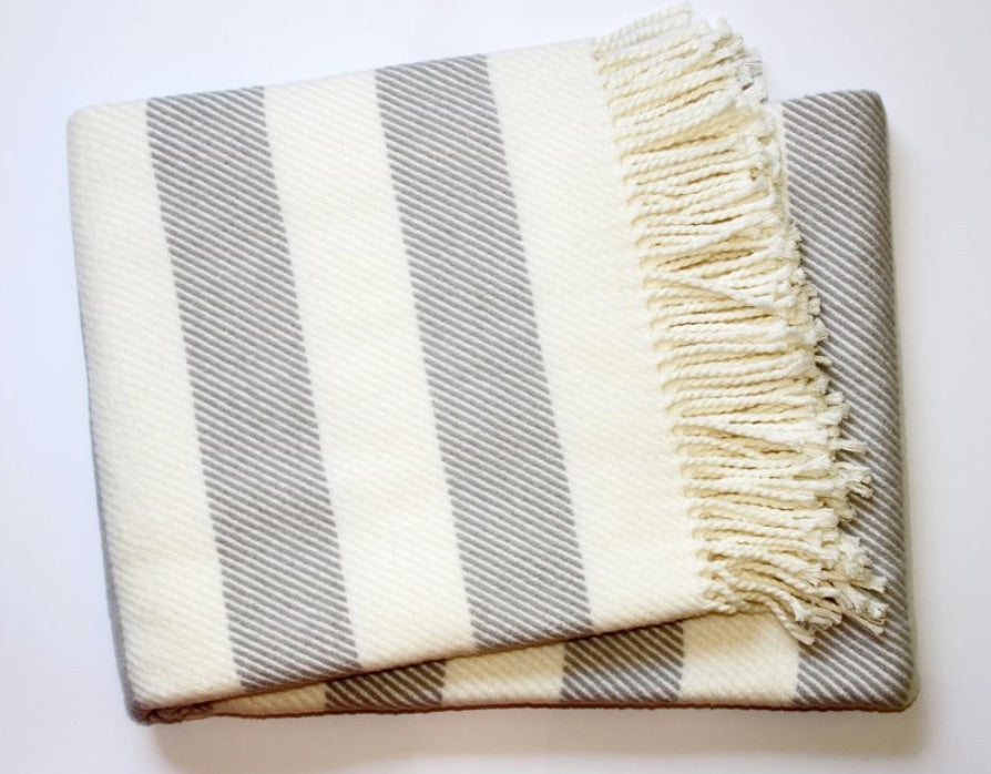 The A Soft Idea Personalized Throw Blanket features wide, diagonal cream and light gray stripes with fringe trim on one edge, shown on a white background.