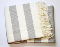 The A Soft Idea Personalized Throw Blanket features wide, diagonal cream and light gray stripes with fringe trim on one edge, shown on a white background.