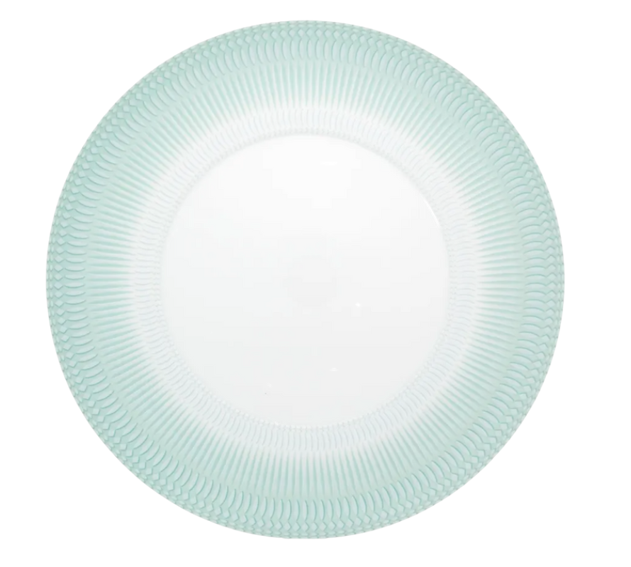 The Venezia Dinnerware by Vista Alegre is a round white porcelain plate with a smooth center and a textured, light blue-green rim featuring a scallop-like pattern.