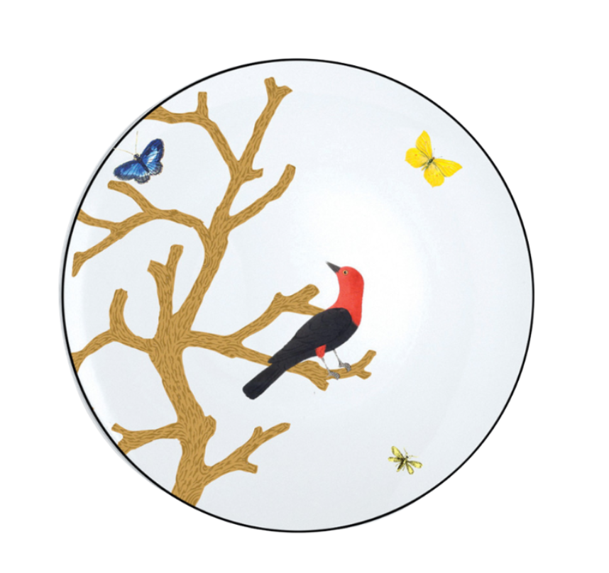 The Bernardaud Aux Oiseaux Dinnerware plate is crafted from white Limoges porcelain and features a brown tree branch, a red and black bird perched on it, and three butterflies in blue, yellow, and green nearby.