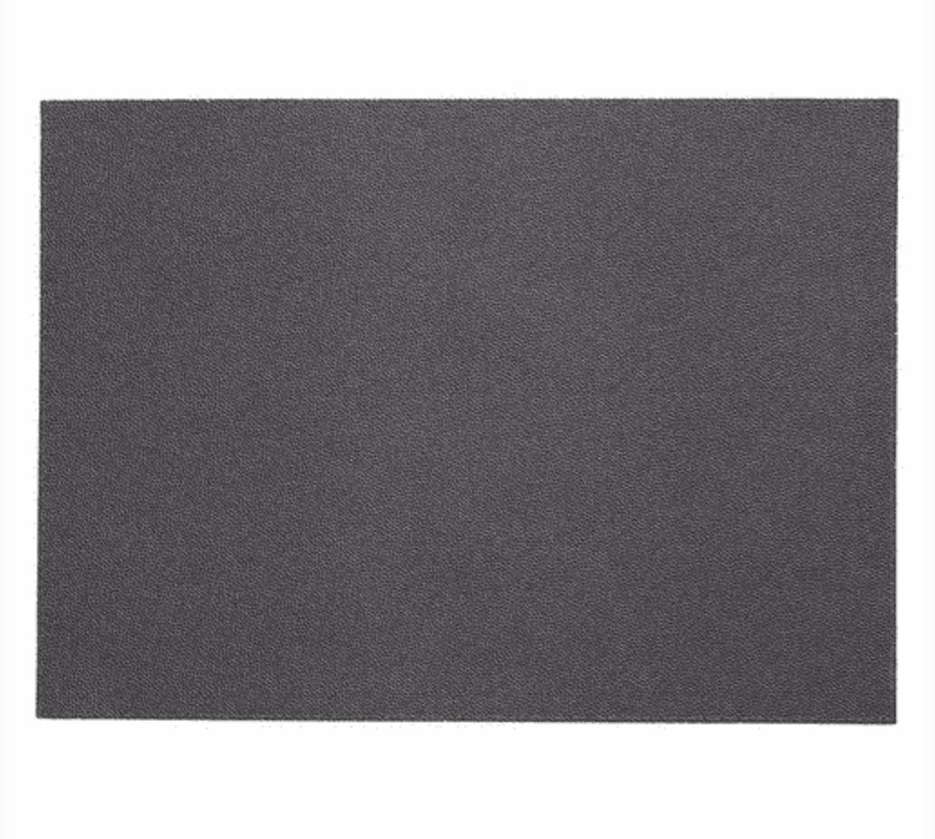 A set of four rectangular black placemats from Bodrum’s Skate collection, featuring a fine, gritty texture and displayed against a white background.
