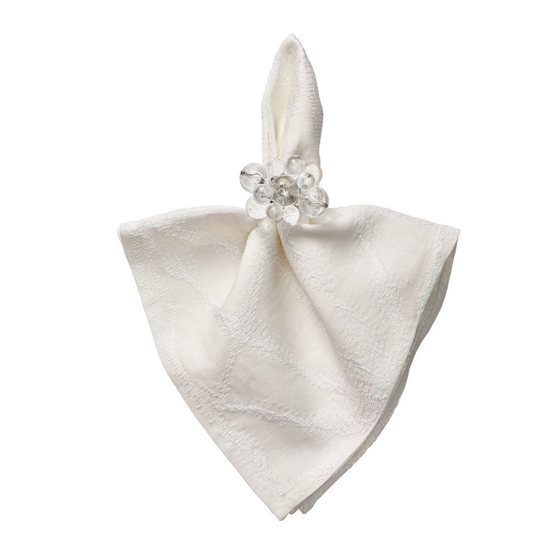A folded white cloth napkin is held by a Kim Seybert Cloud Napkin Ring from the Set of 4, featuring clear round acrylic baubles, displayed against a plain white background.