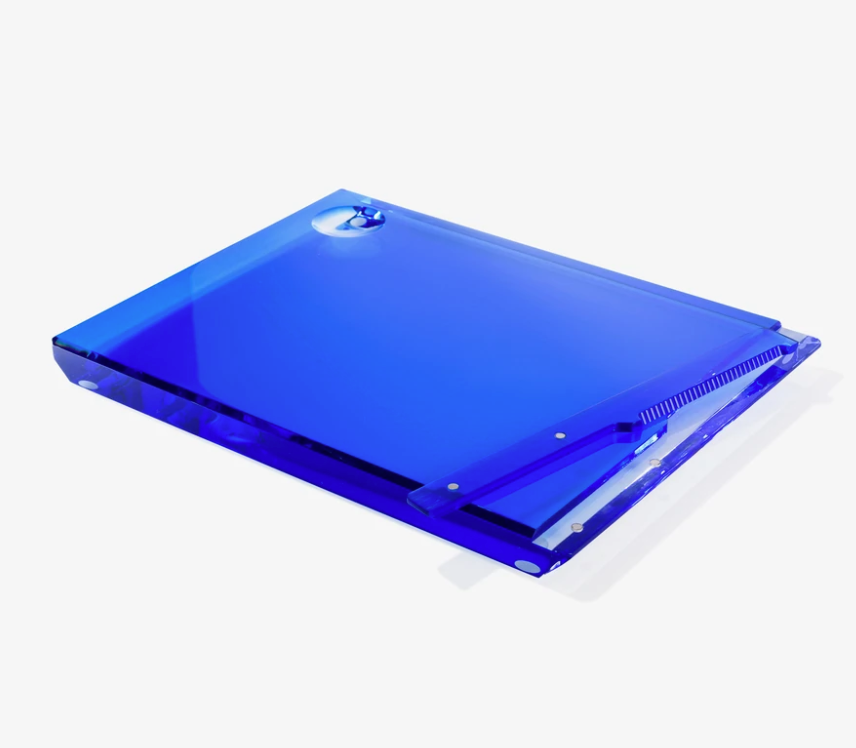The Apeloig Personalized Solid Acrylic Challah Board is a translucent blue, rectangular board with a matching blue clip and a round hole in the top left corner, shown on a white background.