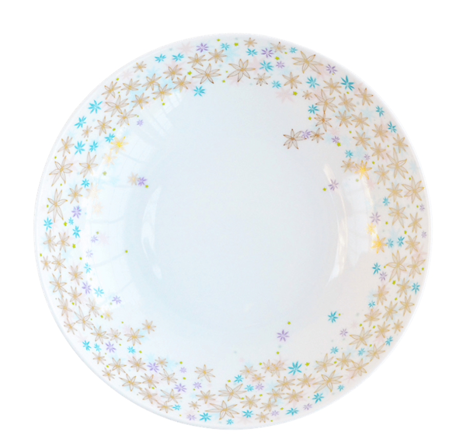 The Fèerie by Michael Cailloux plate from Bernardaud is a round white Limoges porcelain piece featuring a gold, blue, and purple star-shaped floral border around the rim with a plain center. Part of the Fèerie Dinner Collection.