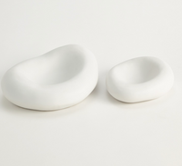 Two Balloon Bowl White ceramic bowls by Global Views/Surya, featuring a matte finish and organic edges, are placed side by side on a white surface. The left bowl is larger than the right.