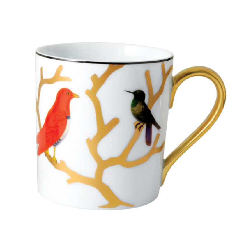 The Aux Oiseaux Dinnerware mug by Bernardaud is crafted from white Limoges porcelain, featuring a gold handle, gold branch motifs, and two colorful birds—one red and one green—perched on the branches.
