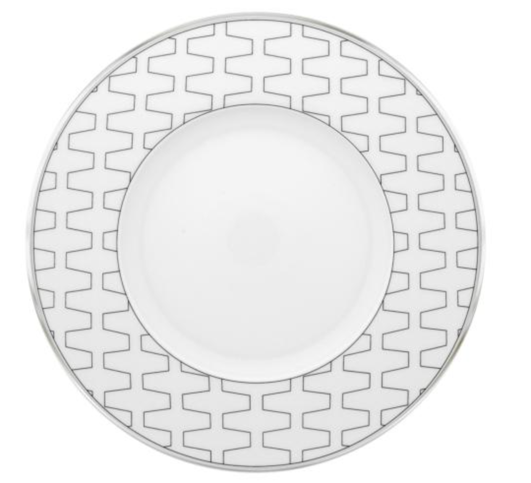 The Trasso Dinnerware by Vista Alegre features a white porcelain plate with a wide rim adorned with a gray geometric zigzag pattern and a plain white center.