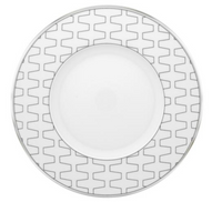 The Trasso Dinnerware by Vista Alegre features a white porcelain plate with a wide rim adorned with a gray geometric zigzag pattern and a plain white center.