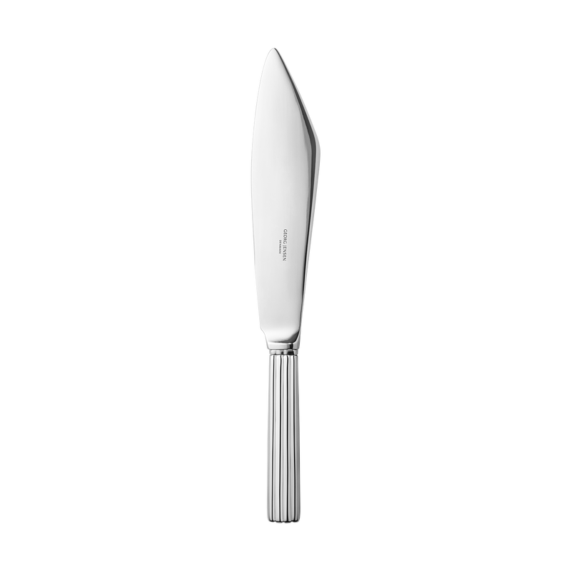A Georg Jensen Bernadotte Cake Knife with a smooth, mirror-polished steel blade and ribbed handle is displayed on a plain white background.