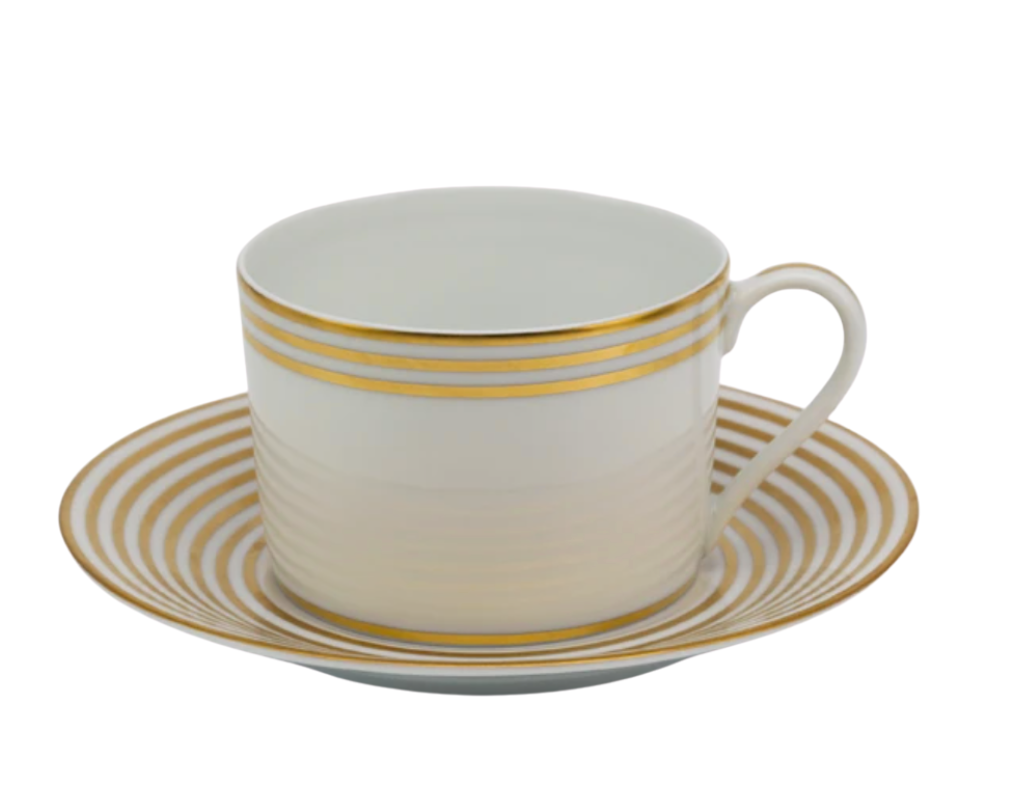 The Latitudes Dinnerware teacup by Royal Limoges features gold horizontal stripes, and its matching saucer displays concentric gold circles, both on elegant white porcelain.