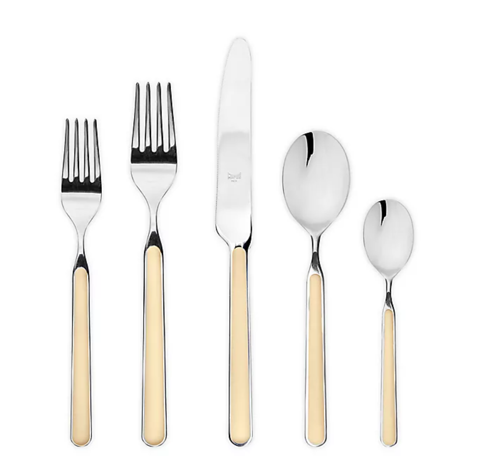 The Mepra Fantasia Flatware 5 Piece Set, shown in beige, features two forks, a knife, a soup spoon, and a teaspoon with resin handles—stylish, dishwasher safe flatware available in 16 colors. All pieces are neatly arranged on a white background.