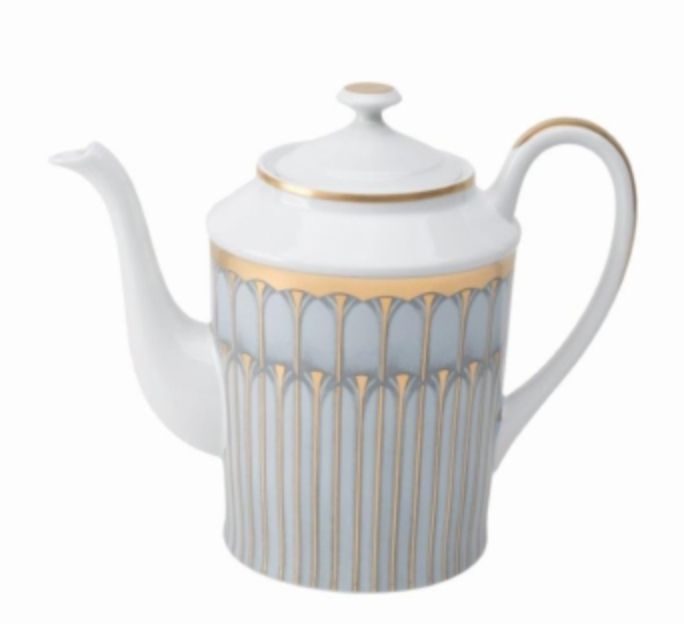 A white porcelain teapot with a curved spout and handle, adorned with gold and silver geometric patterns, from Philippe Deshoulieres’ Arcades Gold Dinnerware collection, featuring a matching lid accented with a gold rim.