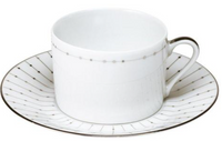 The Carrousel Dinnerware by Philippe Deshoulieres features a white Limoges porcelain teacup with handle and matching saucer, both adorned with thin platinum lines and dotted rim patterns for an elegant, delicate style.