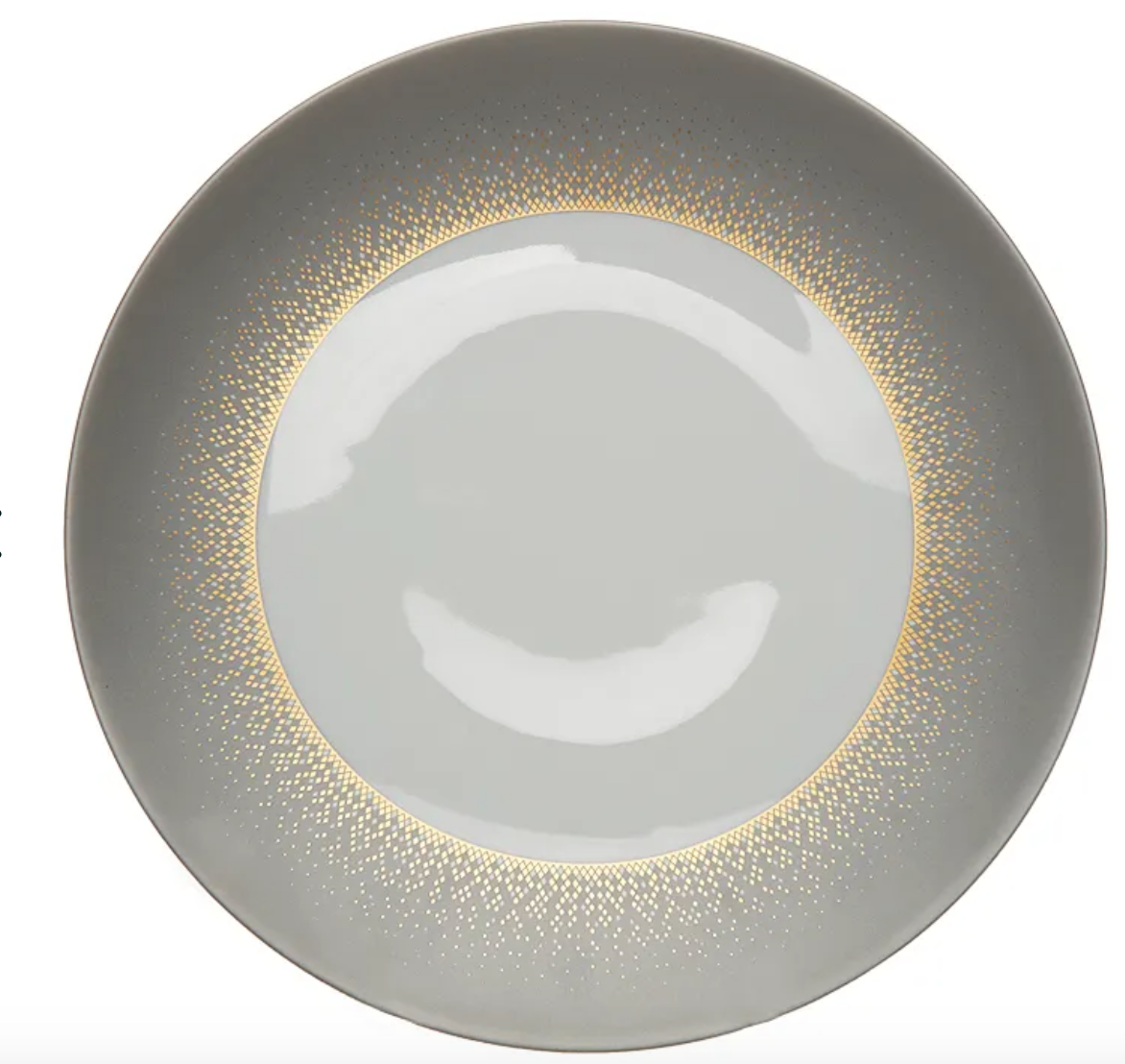 The Haviland Souffle D'or Dinnerware features a round, light gray ceramic plate with a glossy center and a gradient ring of small gold dots near the rim, blending classic Limoges-inspired elegance with modern handmade style.