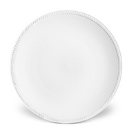 The Soie Tressée White Dinnerware by L'Objet features a round, plain white Limoges porcelain dinner plate with a subtle braided rim pattern, shown from above on a white background.