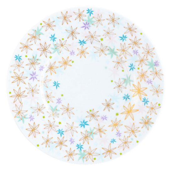 The Fèerie By Michael Cailloux plate by Bernardaud is round, crafted from fine Limoges porcelain, and features a rim decorated with gold, blue, and purple multicolored flowers while the center remains plain.