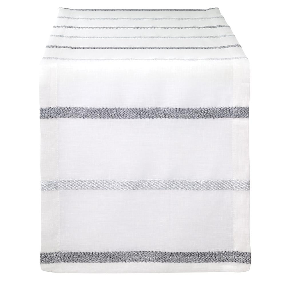 The Bodrum Metallic Band Silver Table Runner features a sleek, minimalist design with metallic silver bands, elegantly draped over the edge of a table.