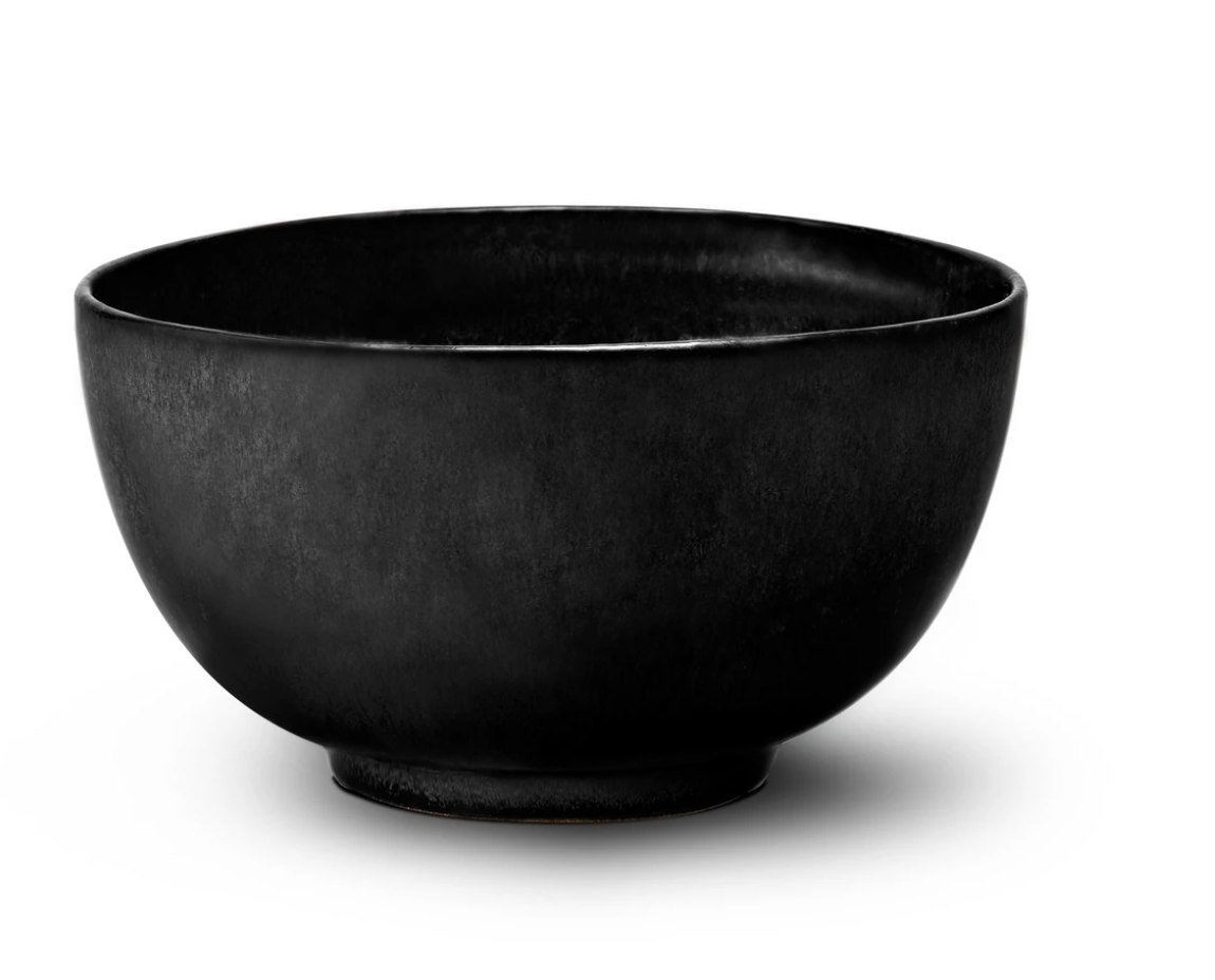 A minimalist matte black ceramic bowl from the Terra Iron Dinnerware collection by L'Objet is shown against a white background with a subtle shadow underneath.