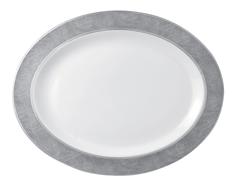 A top view of the Bernardaud Sauvage Grey & Platinum dinnerware plate, featuring an oval shape, white surface, and a platinum snake skin-embossed rim against a plain background.