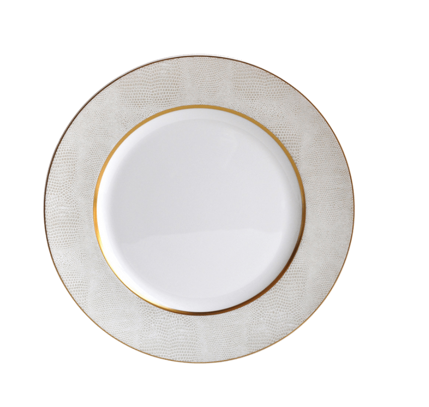 The Sauvage Gold Dinnerware by Bernardaud is a white Limoges porcelain plate featuring an embossed snake skin–textured rim and a thin gold band near the inner edge, shown from above on a white background.
