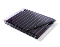 The Striped Acrylic Challah Board & Knife by Apeloig features a transparent purple design with evenly spaced grooves and a matching serrated knife, perfect for a modern table setting.