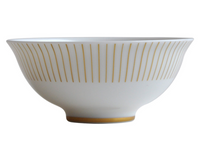 The Sol Dinnerware bowl by Bernardaud is crafted from white Limoges porcelain with a flared rim, featuring thin vertical gold lines and a gold band at the base for an elegant 24k gold-accented design.