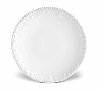 The Haas Mojave White Dinnerware by L'Objet is a round porcelain plate with an embossed floral and berry rim, displayed against a white background.