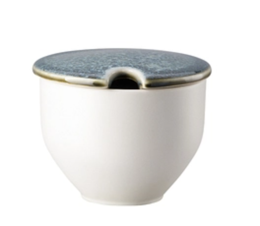 The Rosenthal Junto Aquamarine Dinnerware features a white ceramic container with a rounded base and blue-gray lid with a notched rim—ideal for holding a spoon and complementing your stoneware collection.