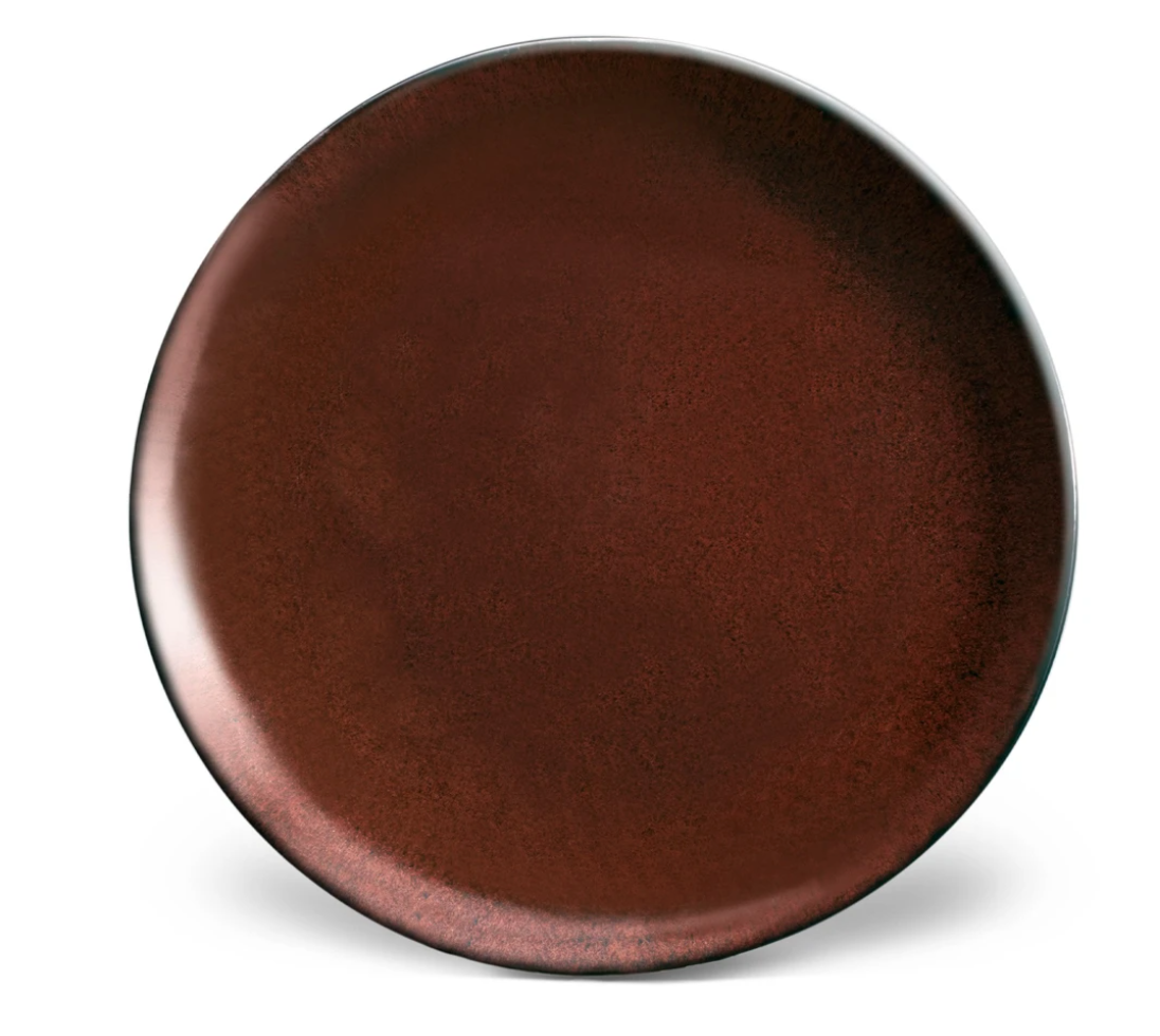 The Terra Wine Dinnerware plate by L'Objet is a round, dark brown handcrafted piece with a smooth, slightly glossy finish, displayed on a white background.
