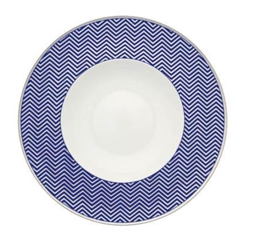 The Vista Alegre Harvard Dinnerware plate features a wide, deep blue zigzag chevron rim and a plain white center, blending classic New England style with elegant porcelain craftsmanship.