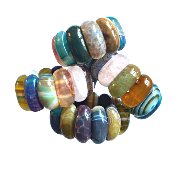 The Whigstock Studio Gemstone Napkin Ring Multi Set of 4 features large, smooth multicolored stone beads in green, amber, purple, and pink—perfect as unique napkin rings or gemstone table decor.