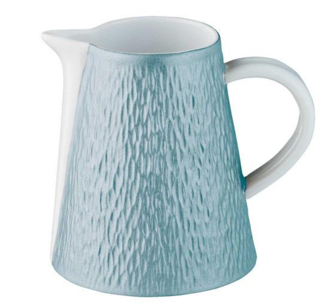 The Raynaud Mineral Irise Dinnerware Sky Blue ceramic pitcher features a textured surface, wide base, narrow top, small spout, and white handle—an ideal addition to modern dinnerware collections.