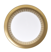 The Bernardaud Sol Dinnerware is a round white plate featuring a wide 24k gold rim with fine, evenly spaced radial lines for a sunburst effect. The center of the plate is plain and unadorned.