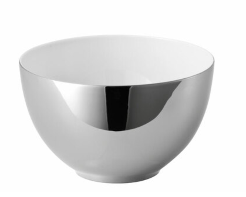 The Rosenthal Skin Platinum TAC 02 Dinnerware features a shiny, round metal bowl with a reflective silver exterior and smooth white interior, reminiscent of fine porcelain, displayed against a plain white background.
