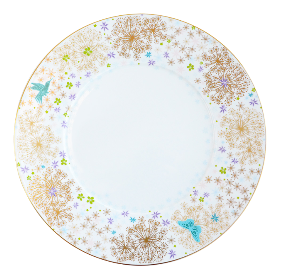 The Fèerie by Michael Cailloux plate from Bernardaud features a gold rim, golden dandelion-like flowers, colorful blooms, a blue hummingbird, and butterfly—showcasing exquisite Limoges porcelain craftsmanship.