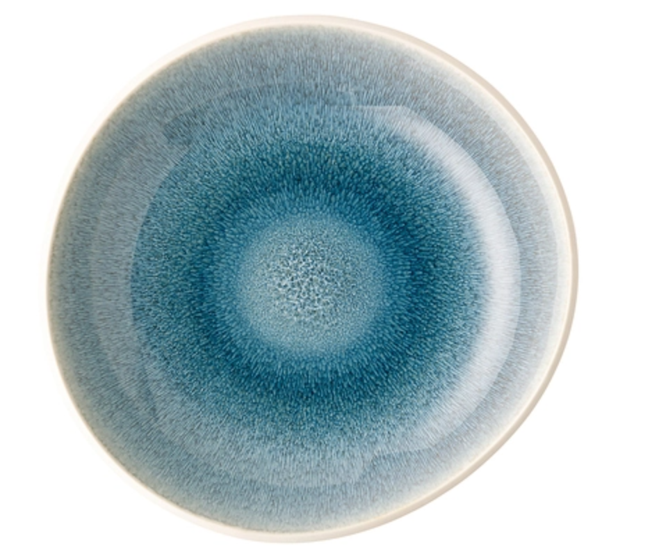 The Rosenthal Junto Aquamarine Dinnerware features a round stoneware plate with a blue gradient reactive glaze that radiates from the center to a lighter, glossy off-white rim. Microwave and dishwasher safe. Set against a white background.