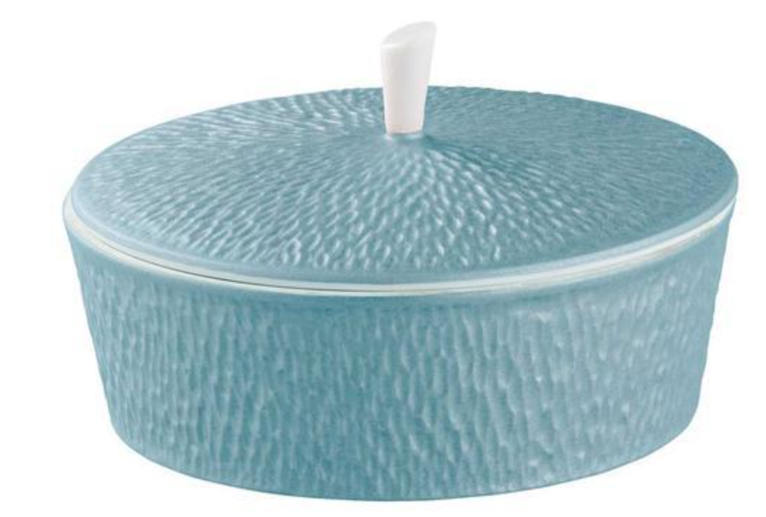 The Raynaud Mineral Irise Dinnerware Sky Blue features a round Limoges porcelain container with a textured surface, matching lid, and white handle—an elegant accent for modern table settings.