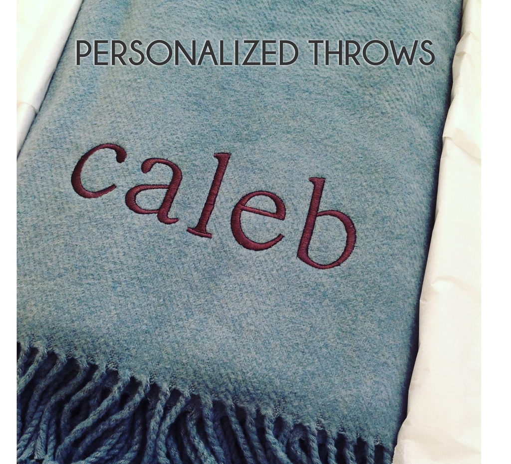 The A Soft Idea Personalized Throw Blanket in light blue features "Caleb" embroidered in maroon and a fringe edge, with "PERSONALIZED THROWS" at the top—a perfect custom addition to any space.