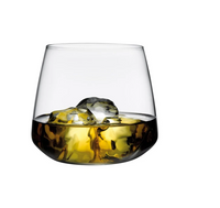 A Mirage Barware tumbler by Nude Glassware, made from lead-free crystal, holds golden-brown liquid and ice cubes, displayed on a plain white background.