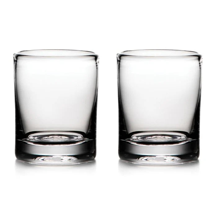 Two empty Ascutney Whiskey glasses by Simon Pearce are placed side by side on a white background.