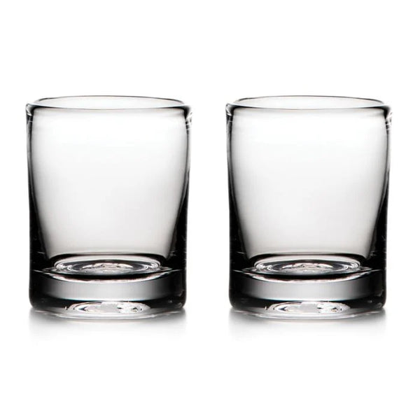 Two empty Ascutney Whiskey glasses by Simon Pearce are placed side by side on a white background.