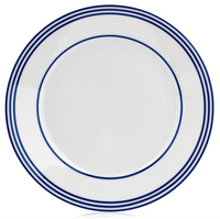 The Latitudes Dinnerware by Royal Limoges is a round white ceramic plate made in France, featuring three evenly spaced blue rings near the rim, displayed on a plain white background.