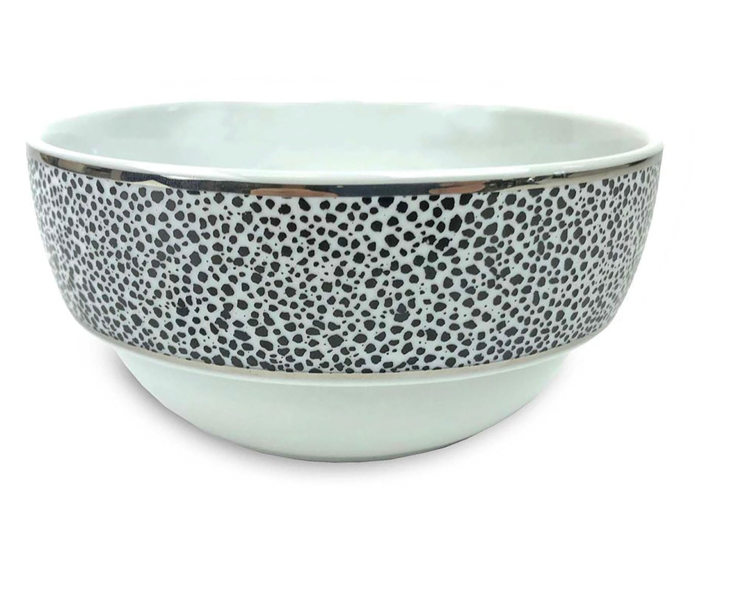 The Panthera Dinnerware Platinum bowl by Michael Wainwright is a modern white ceramic piece with a wide rim, black and gray speckles, and a platinum band, shown on a plain white background.