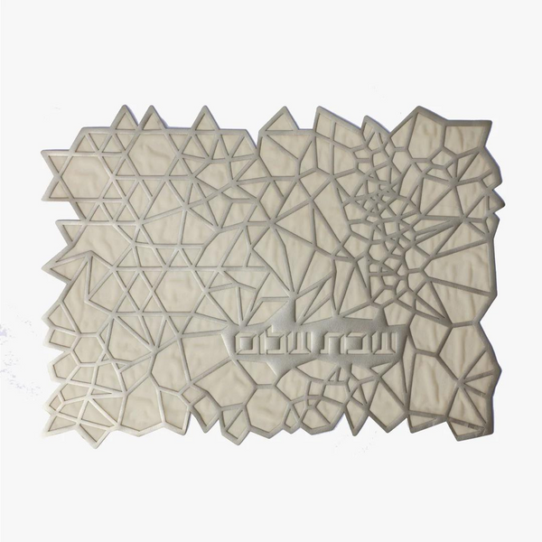 The Apeloig Geometric Challah Cover is a rectangular, laser-cut piece with an abstract pattern of white and light gray polygons and triangles, shown on a plain white background.